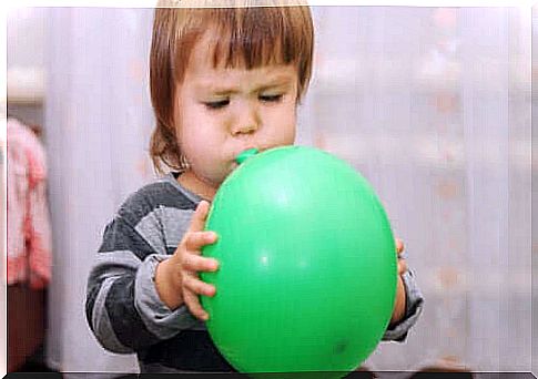 boy inflating balloon