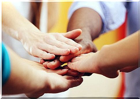 people reaching out their hands to each other