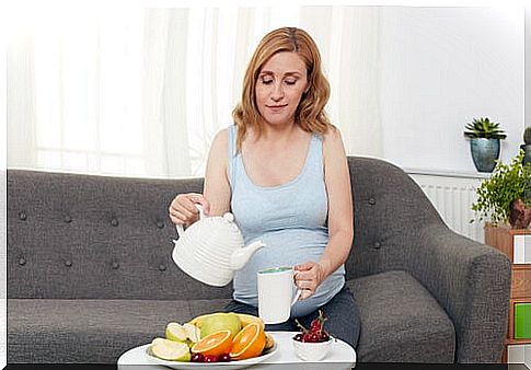 pregnant woman enjoying fruit and tea