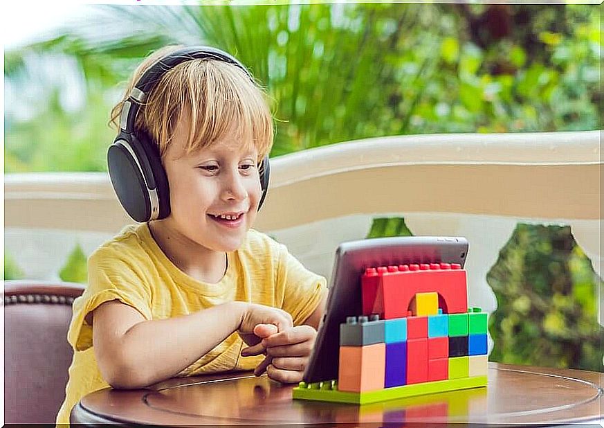 boy watching something funny on a tablet