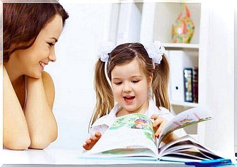 mother and daughter looking in a children's book