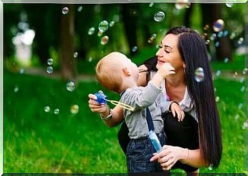 mother and child playing with soap bubbles