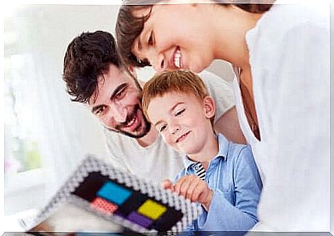 parents looking in book with son