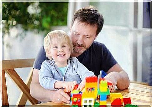 father and son playing with building blocks