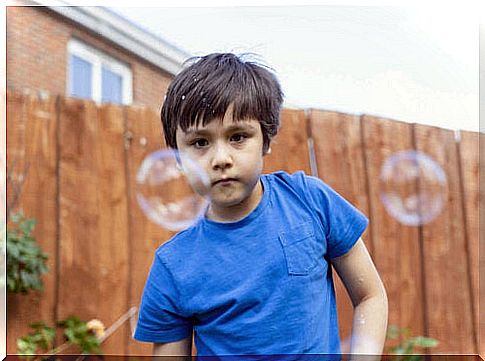 boy looking at soap bubbles