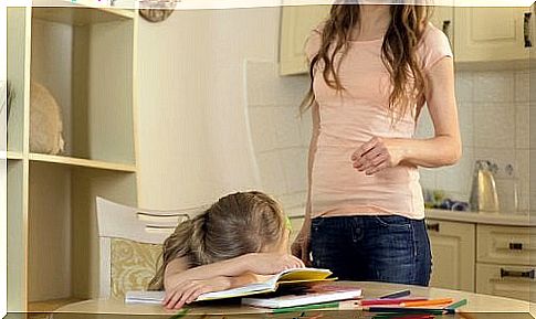 girl lying down over her homework