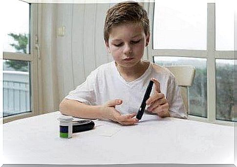 Adolescent diabetes: Boy checks his blood sugar himself.