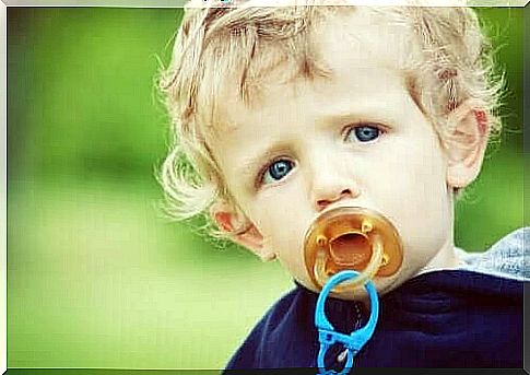 Boy has a pacifier in his mouth