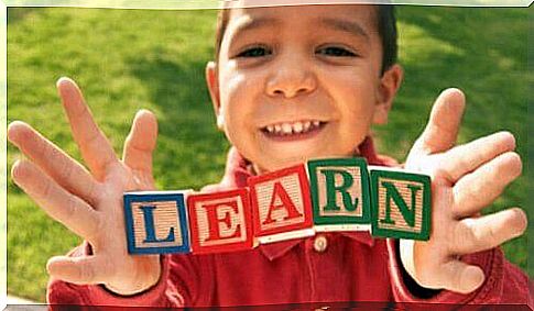 boy holding bricks with letters