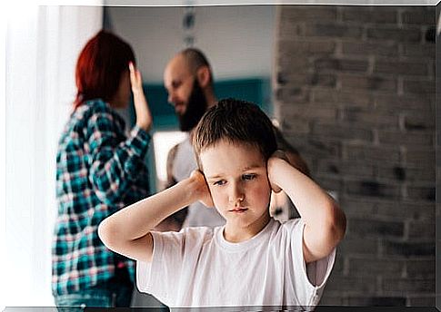 parents arguing and boy holding his ears