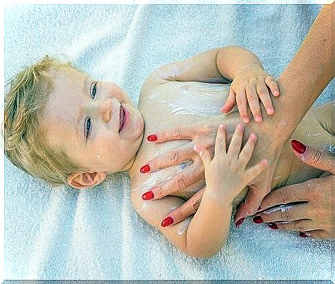 baby gets smeared into cream