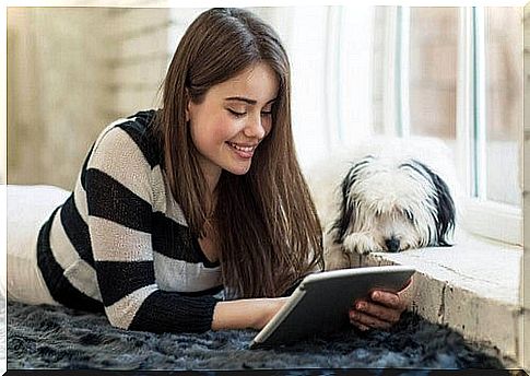 Girl reading a book to her dog