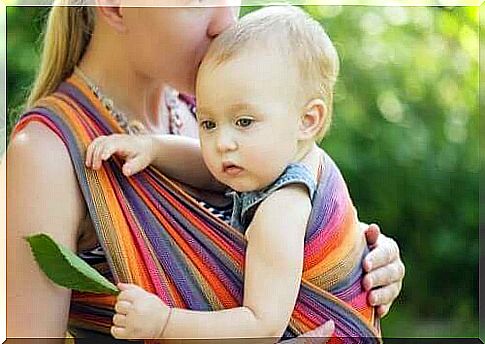 mother carrying baby in wrap