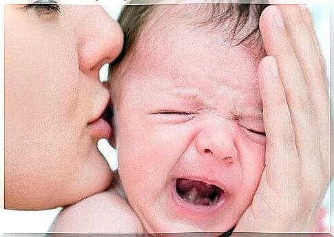 mother comforts her crying baby