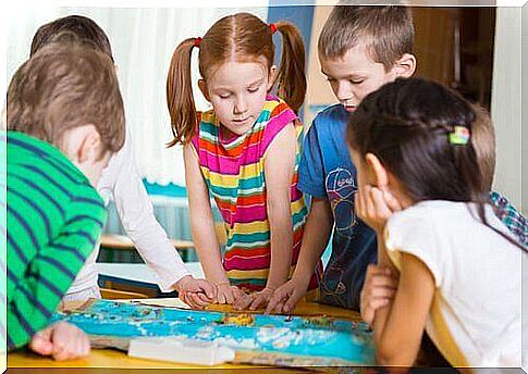 Children play board games as an example of developmental activities for kindergarten children