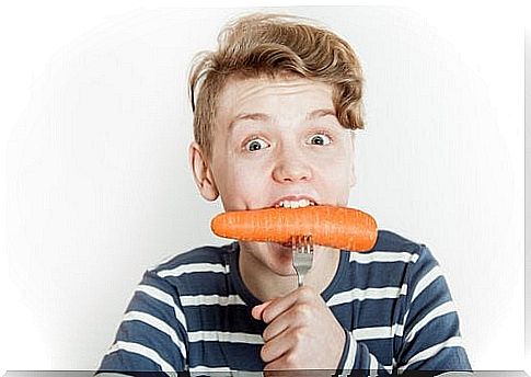 Boy eats carrot