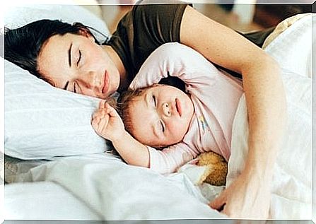 Mother and daughter sleeping together