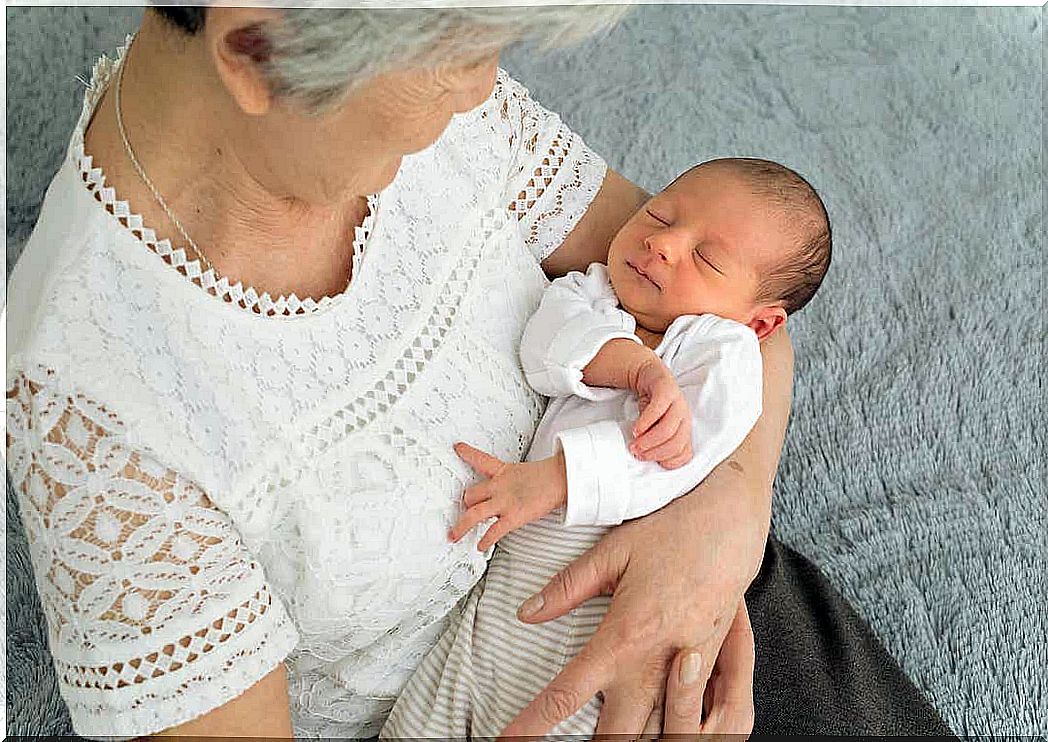 A grandmother stared down at her newborn granddaughter