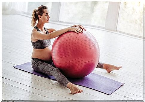 pregnant woman exercising with ball