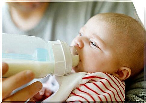 baby drinking from feeding bottle