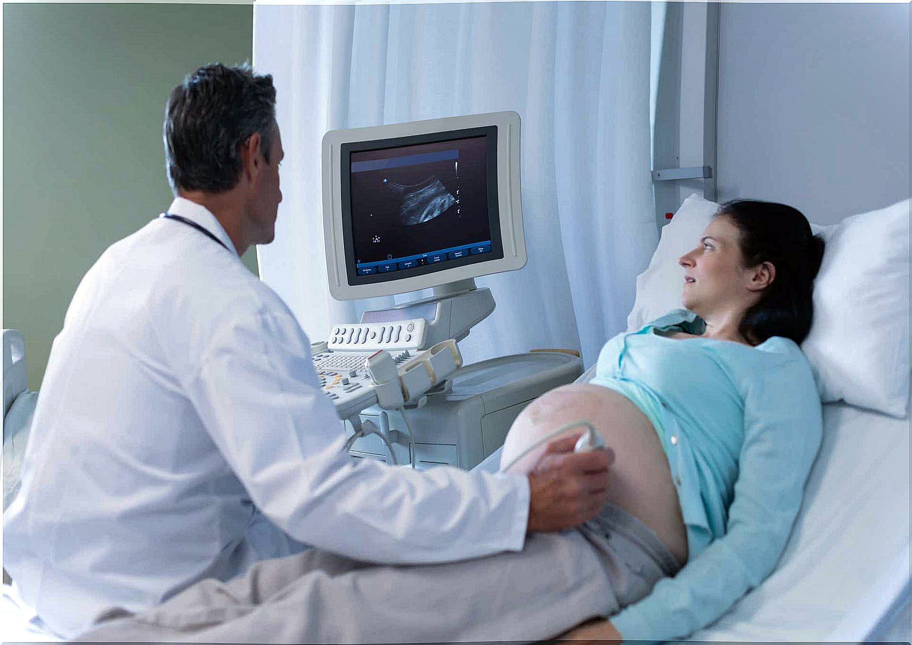 A mother in the last weeks of pregnancy with an ultrasound to look at the development of baby's lungs