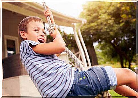 Children swing on ropes