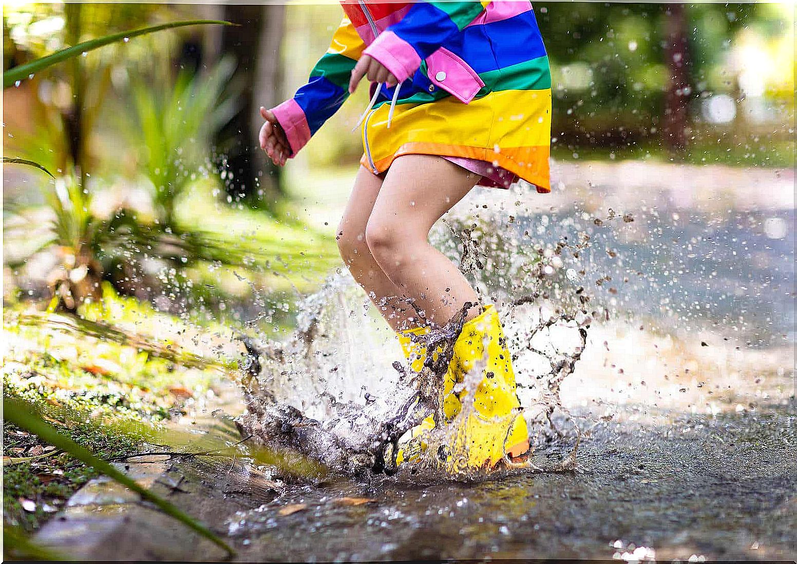 Child jumps in puddles as an example of getting dirty during play