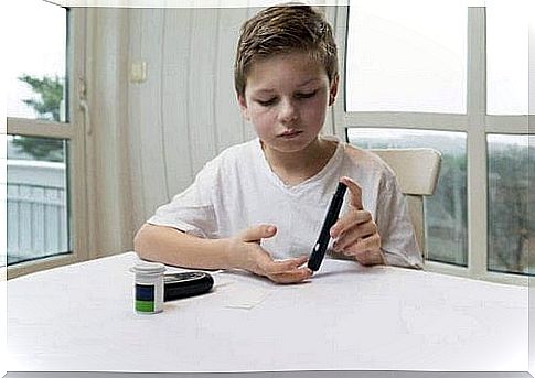 Boy with diabetes measures his blood sugar 