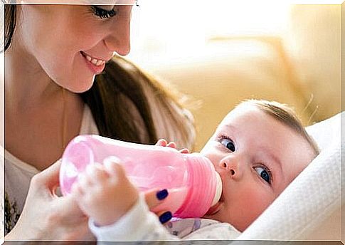 Mother feeding baby with bottle