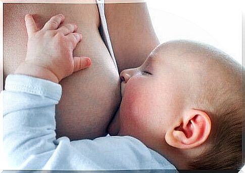 mother breastfeeds baby