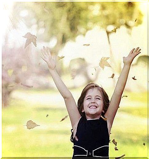 happy girl throws leaves