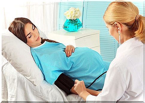 pregnant woman having blood pressure measured