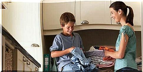 boy helping his mother with laundry