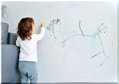 child drawing on wall