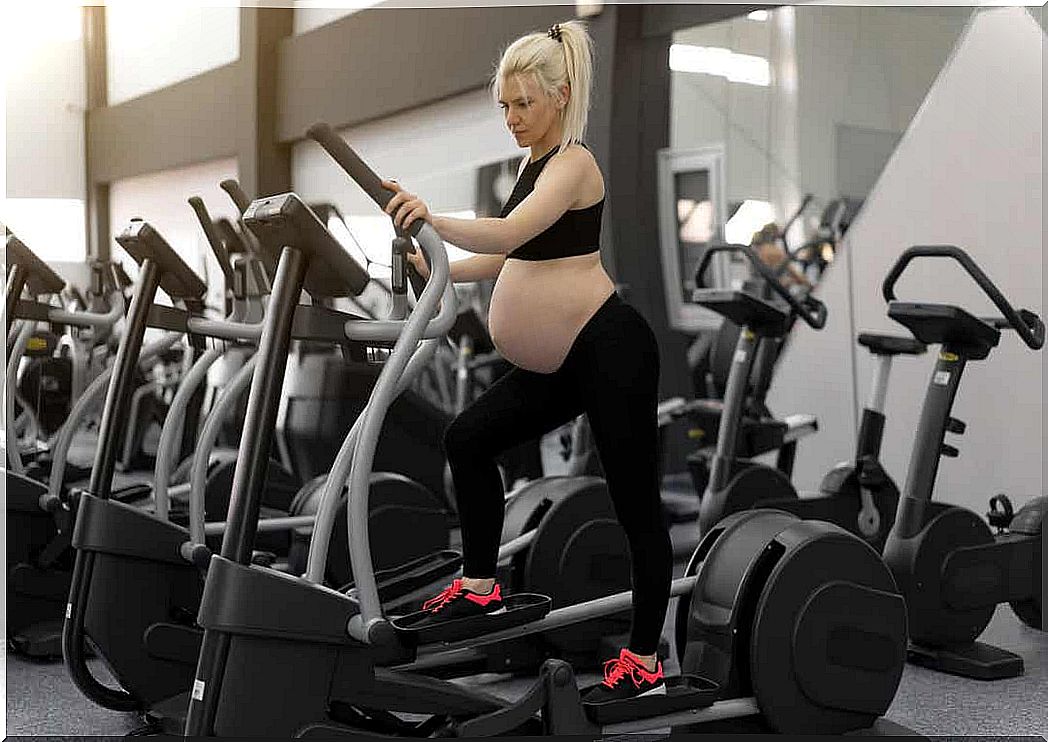 A pregnant woman on a crosstrainer