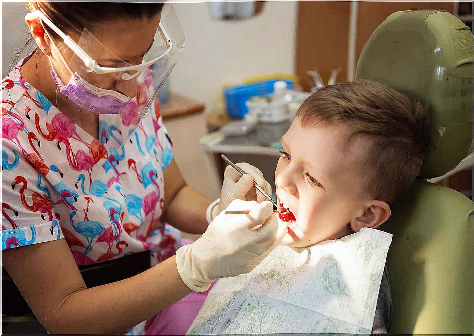 A female dentist treating a young boy