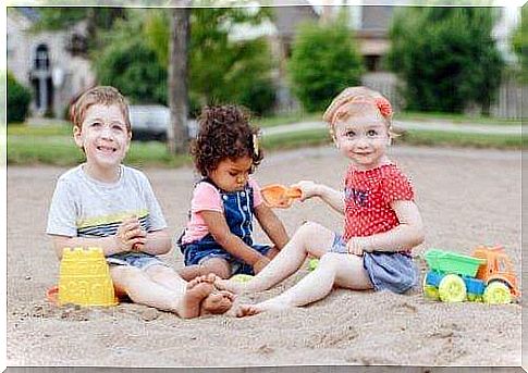 Social skills: Young children play together in sandbox.