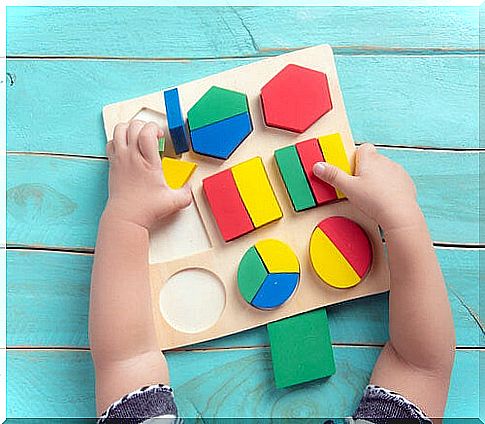 baby playing with figures on a board