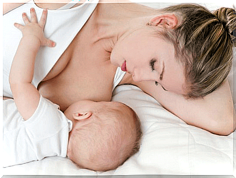 woman lying and breastfeeding baby