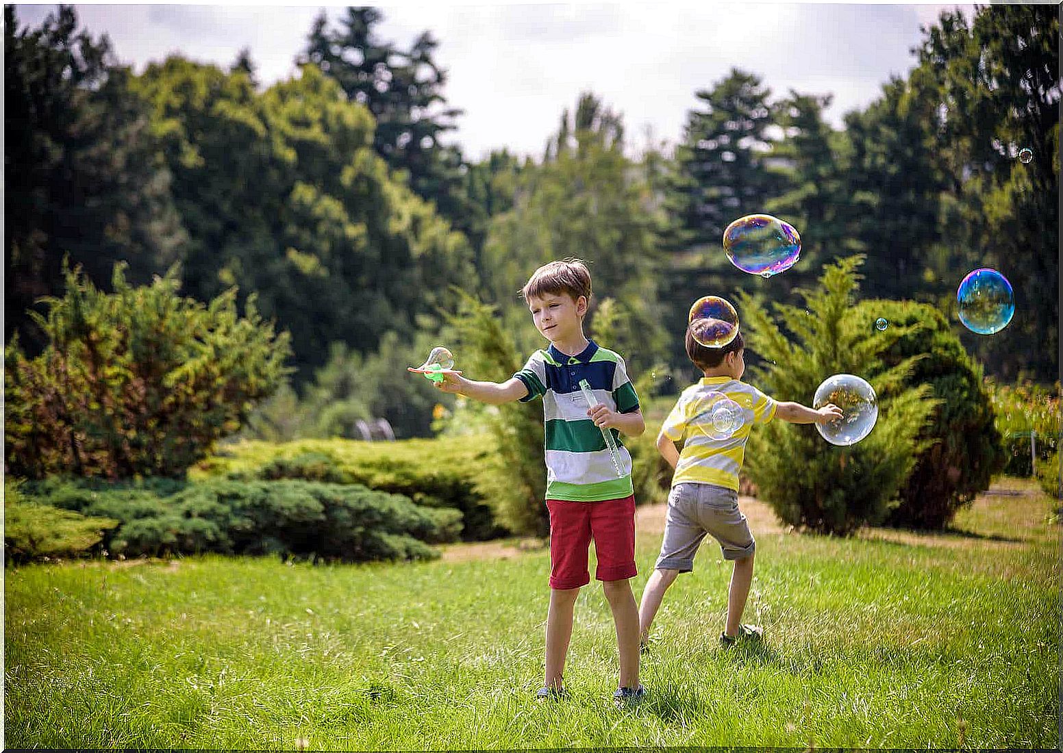 Children blowing bubbles outdoors