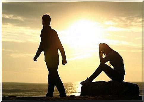 Man leaving woman on beach