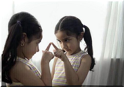 girl pointing at herself in mirror