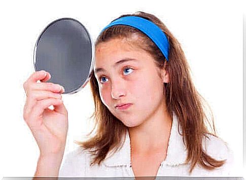 young girl looking in mirror