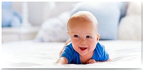 Smiling baby lying on his stomach