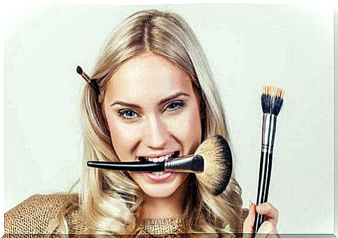 woman with makeup brush in mouth