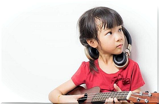 little girl playing guitar