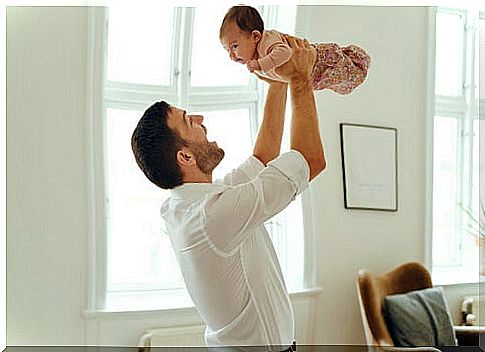 father lifting baby up in the air