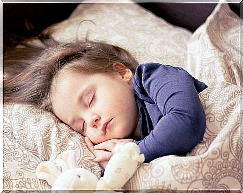 girl sleeping with stuffed animals