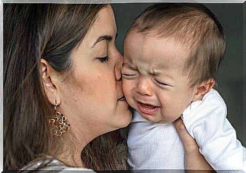 mother comforts her baby after a fall