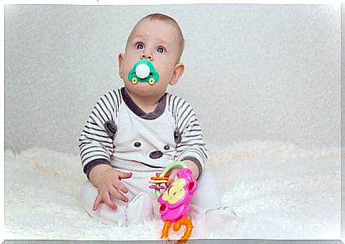 baby with a big pacifier shaped like a car